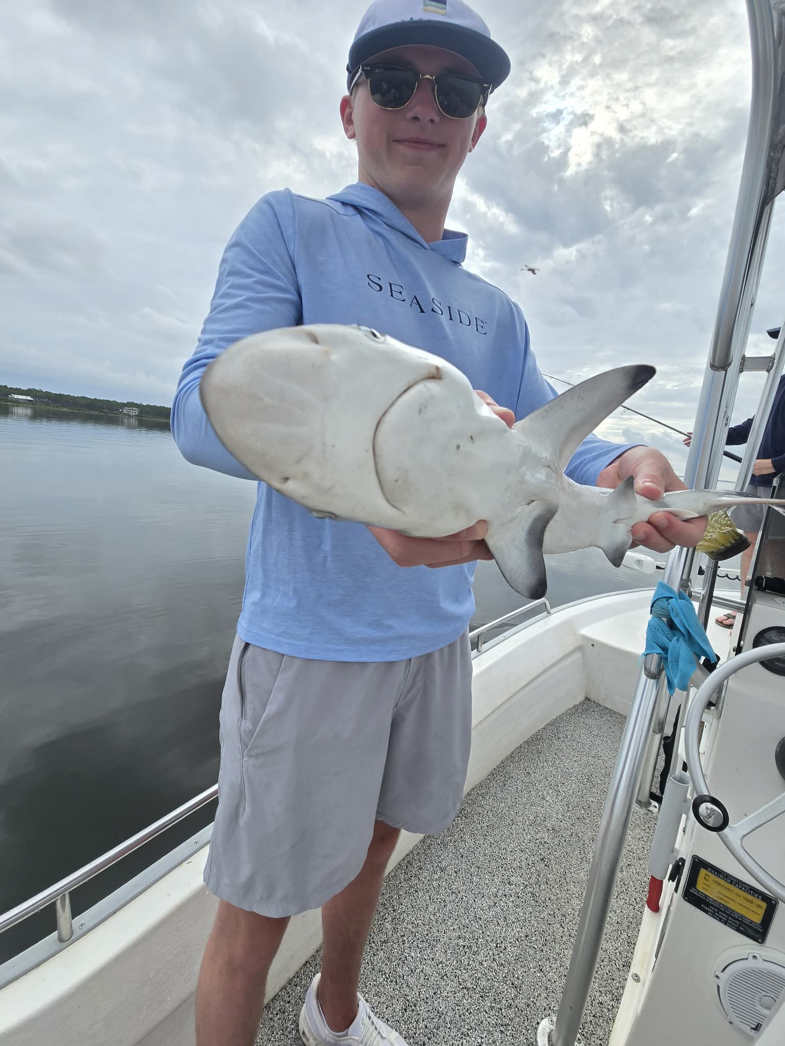 Angler holding a fish during a private 30A bay fishing charter