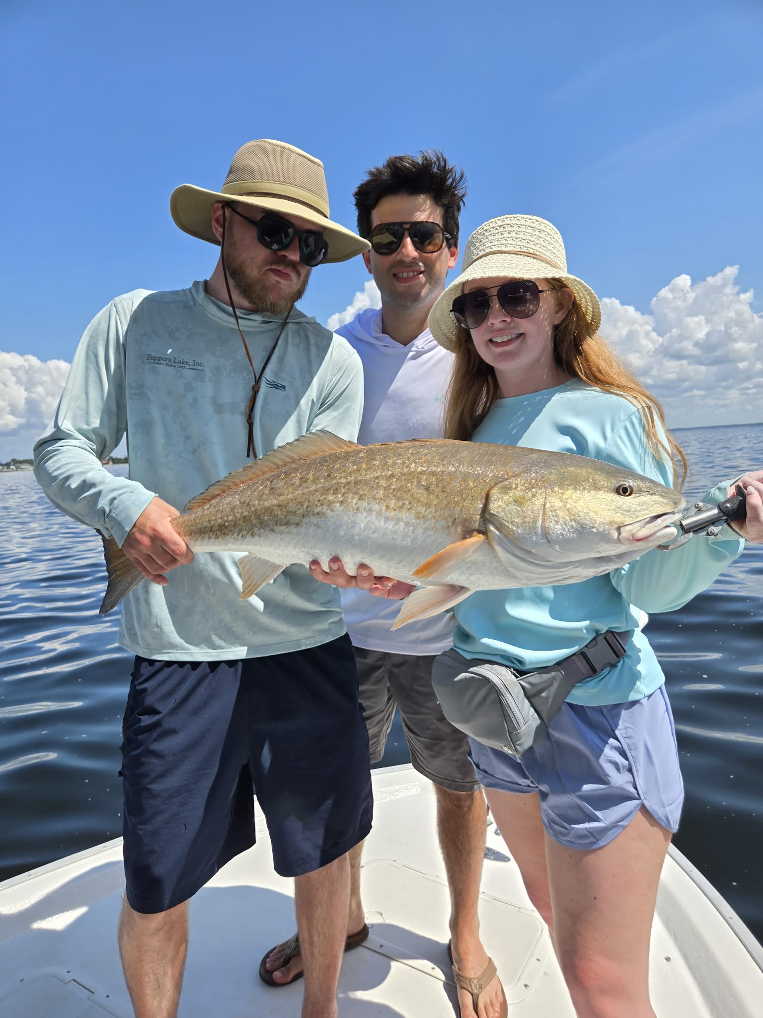 Family fishing charter guest holding a catch near Panama City Beach Florida